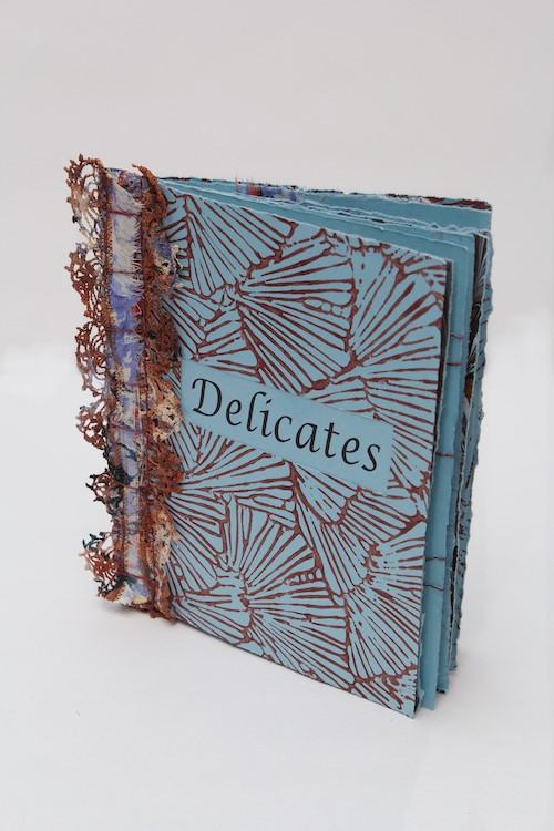 Puncture / Stab bind book by Cristina Hajosy featuring lace details and the word "Delicates" on the front. 