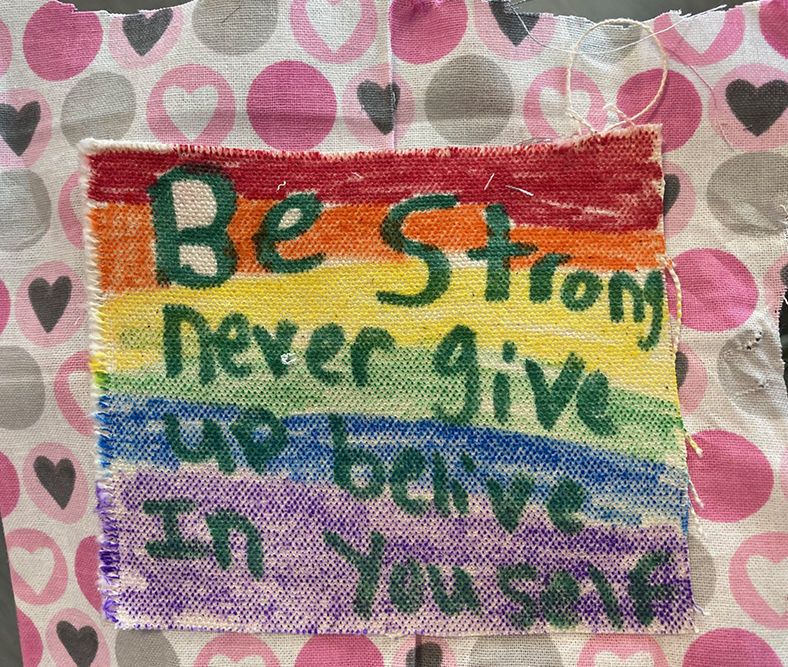 Rainbow patch with writing by Hinda Mandell