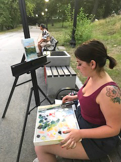Student painting outside