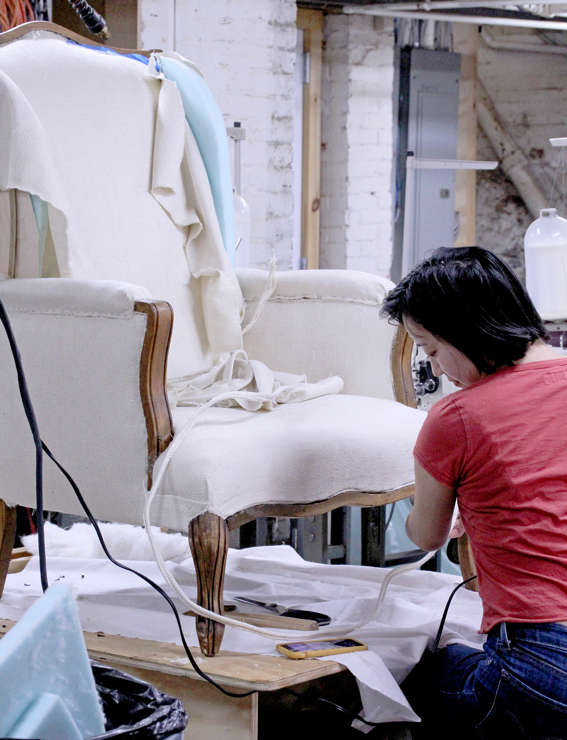 student_working_on_her_chair_in_upholstery